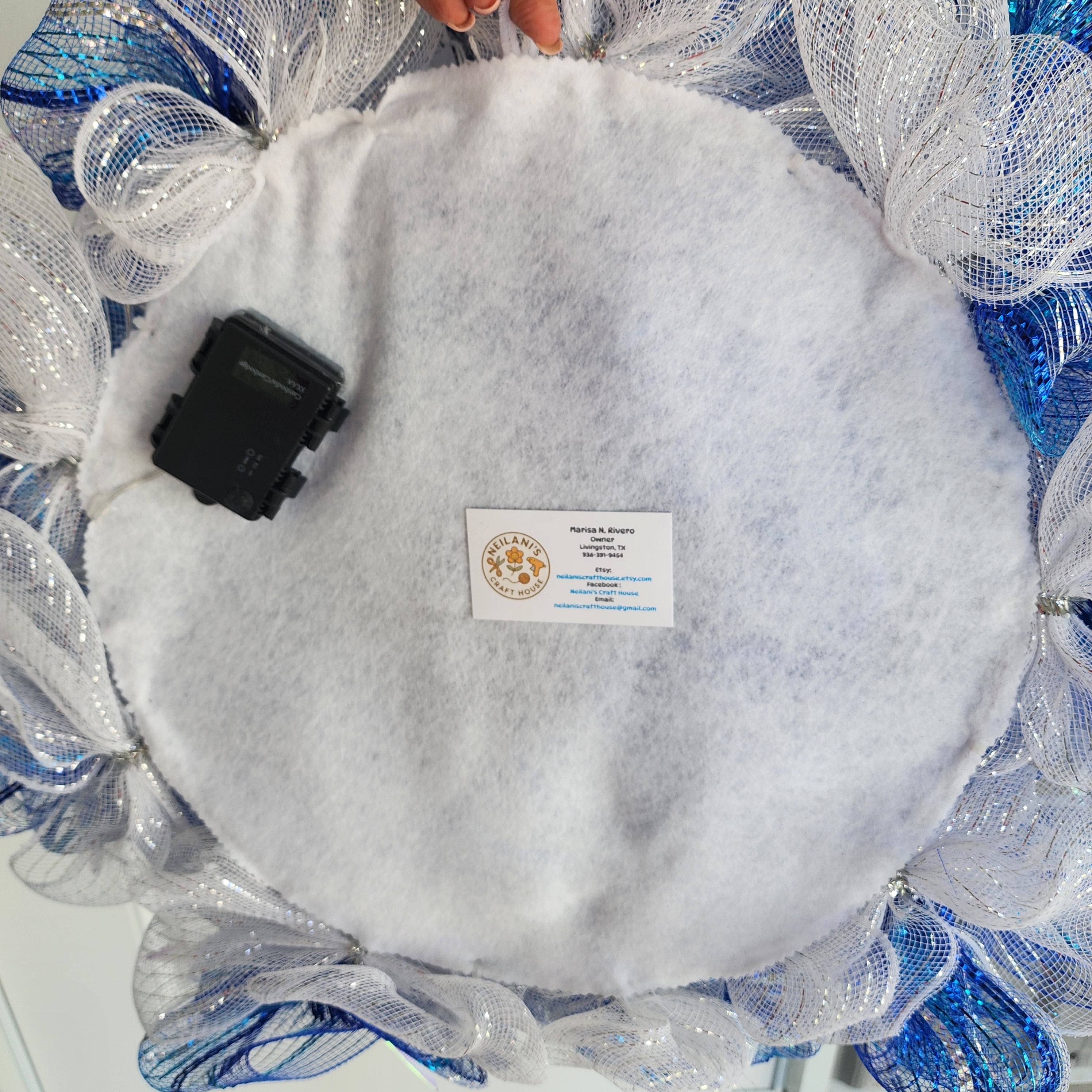 Full wreath front view showing blue silver and white deco mesh