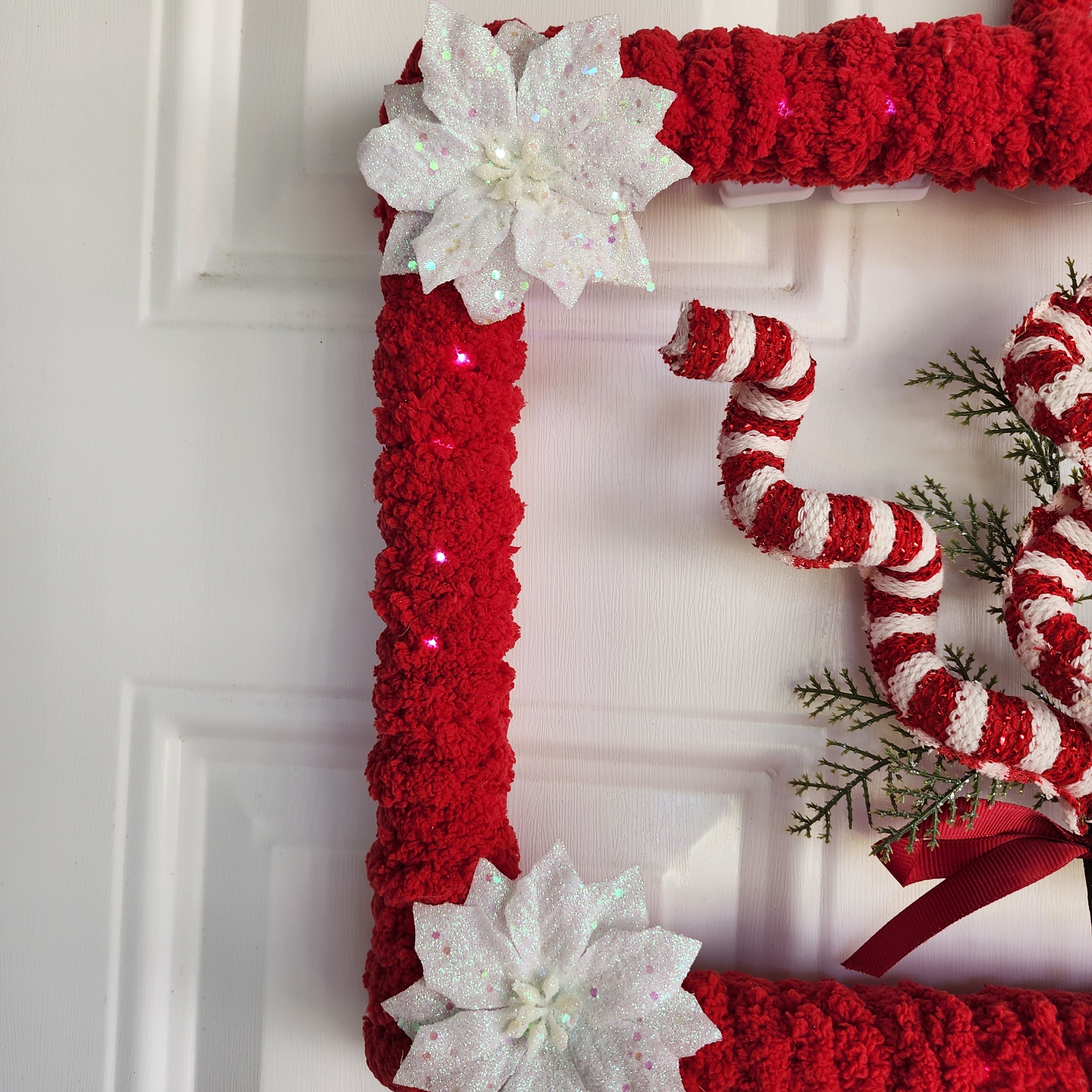 Cedar sprigs and red satin bow accent