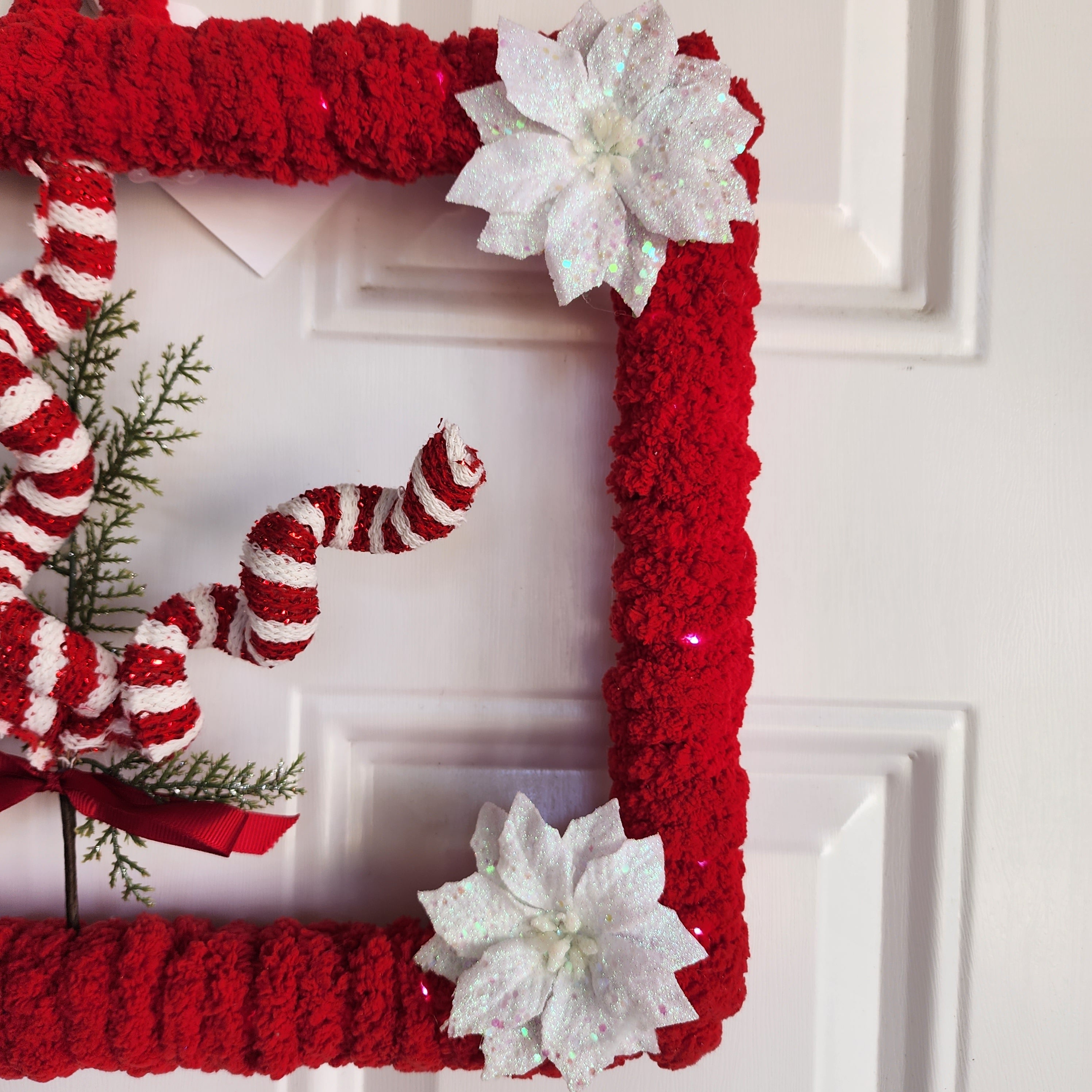 Fairy lights glowing through red yarn detail