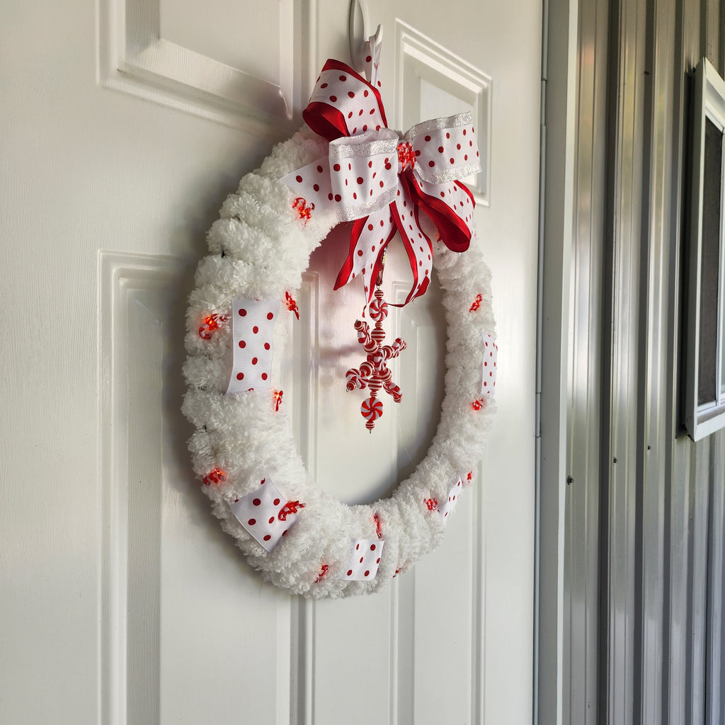 Chunky chenille yarn and candy cane light close-up