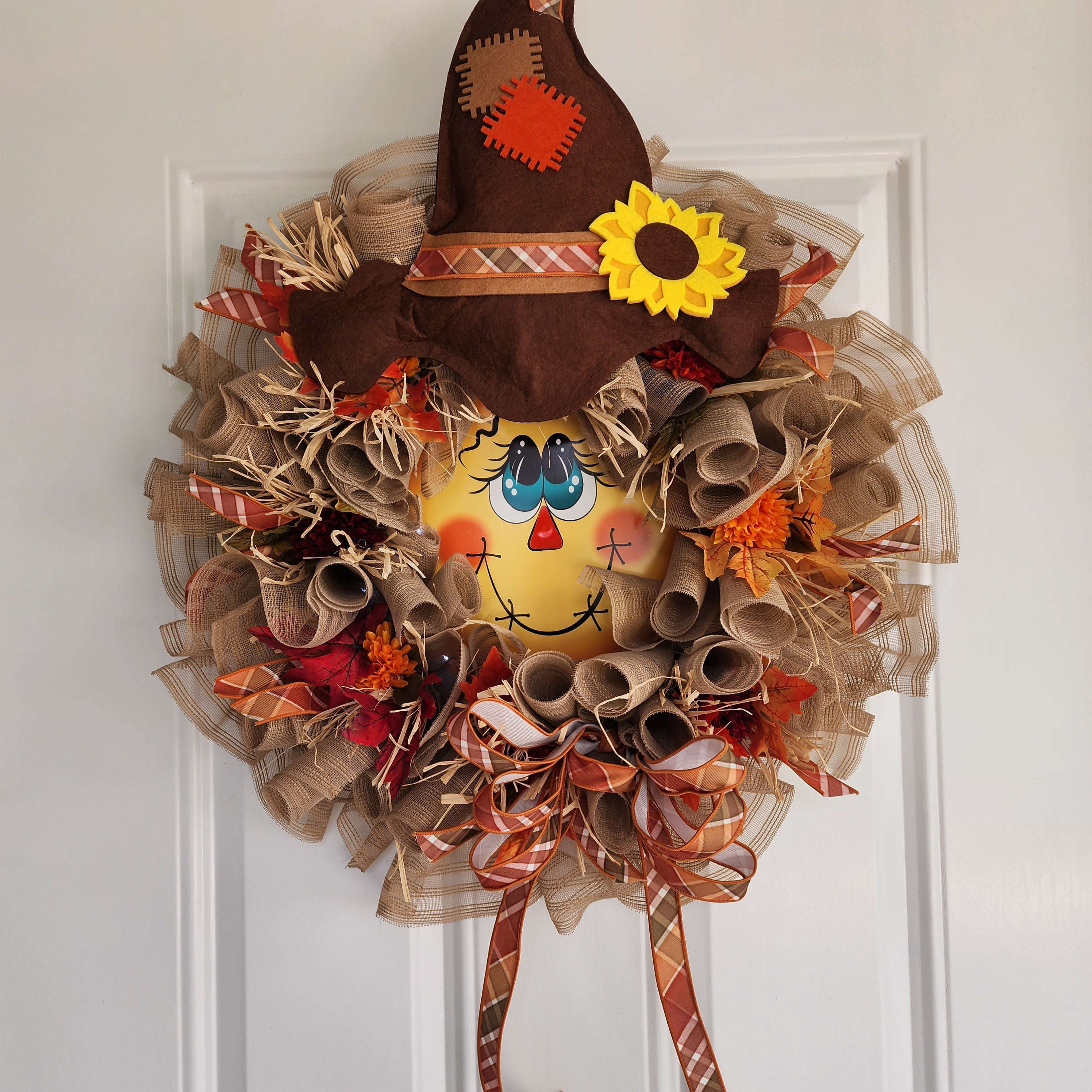 Scarecrow hat with sunflower accent close-up
