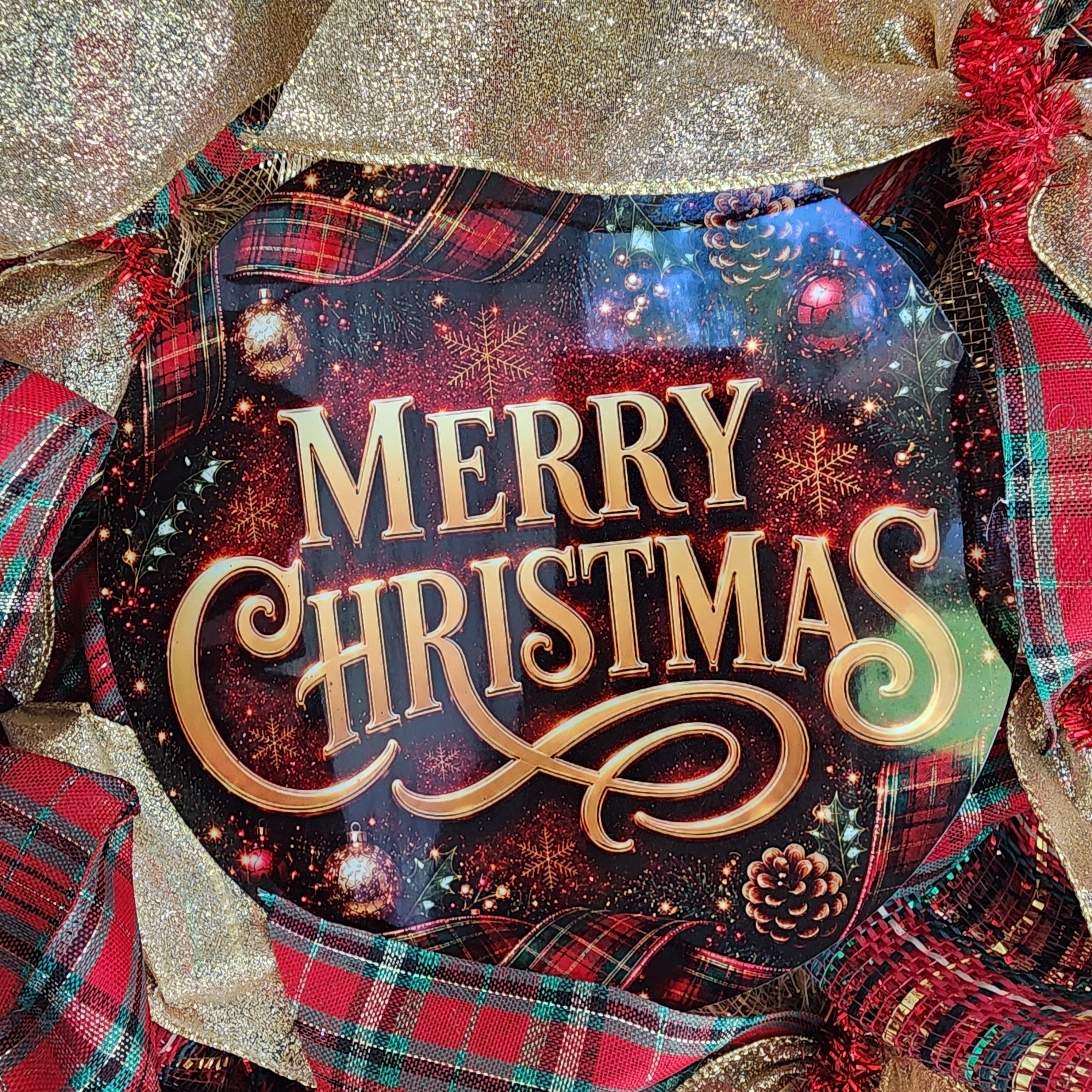 Close-up of Merry Christmas sign and gold ribbon detail