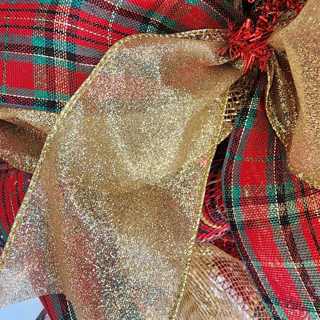 Full Christmas tartan plaid wreath hanging on white front door