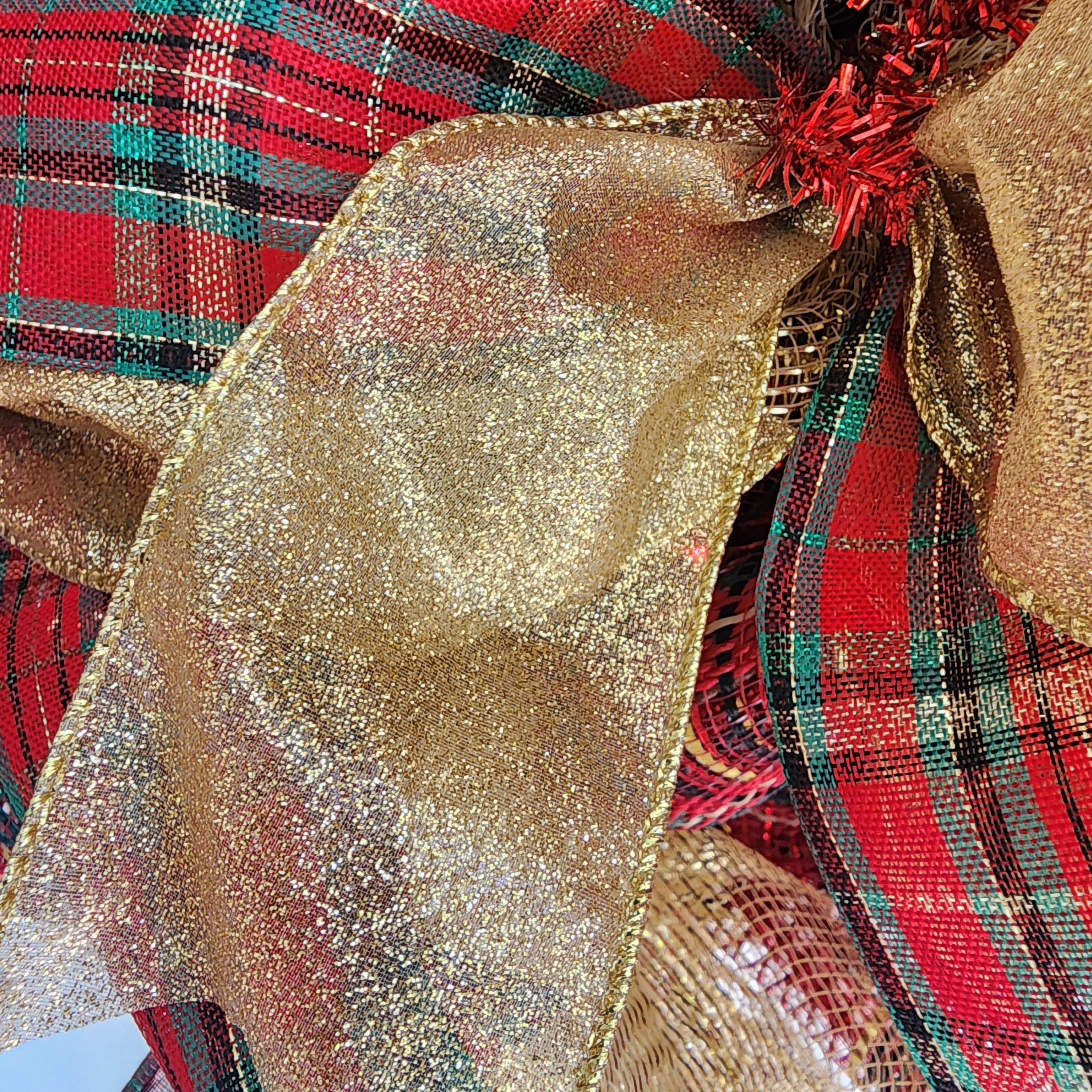 Full Christmas tartan plaid wreath hanging on white front door