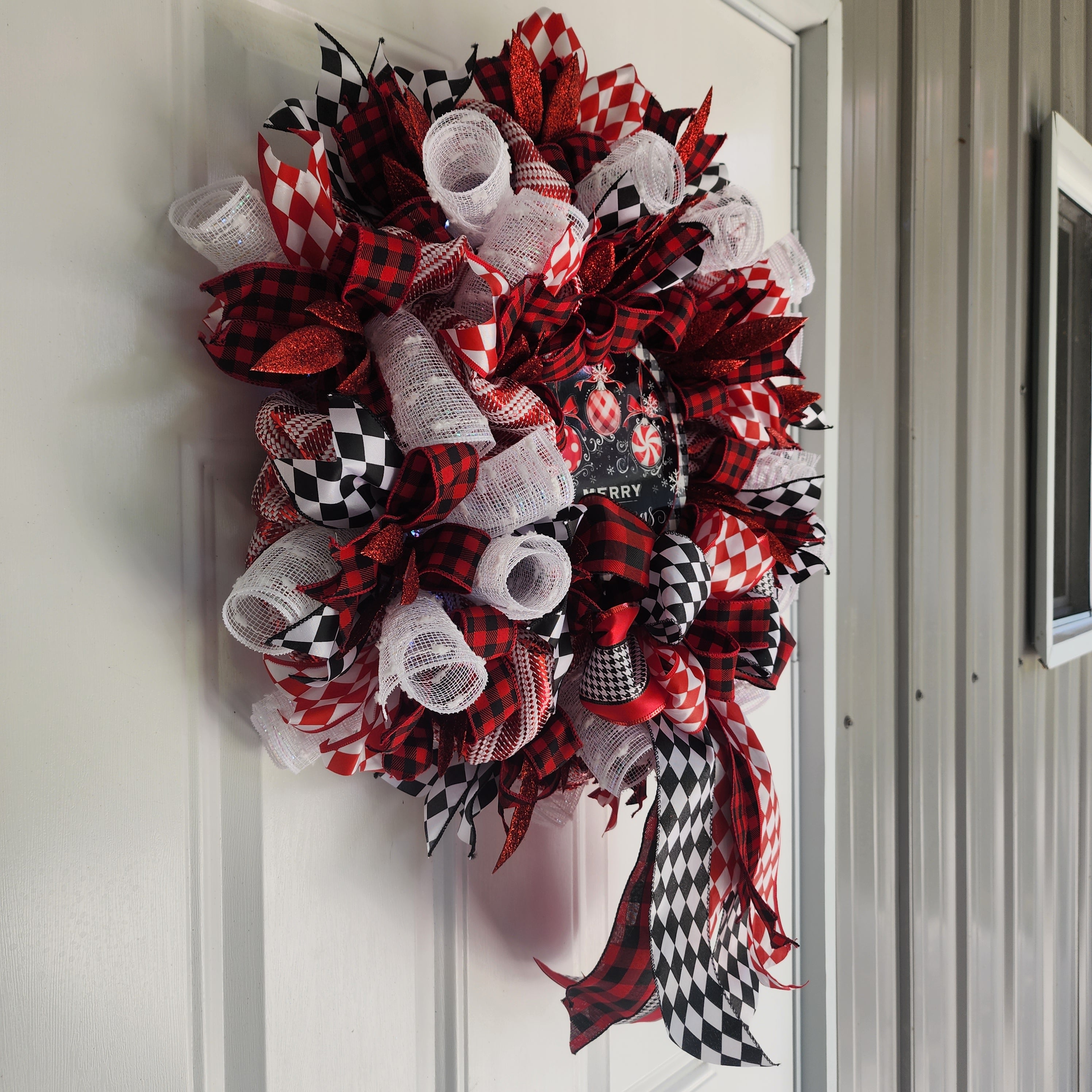 Full wreath hanging on white front door