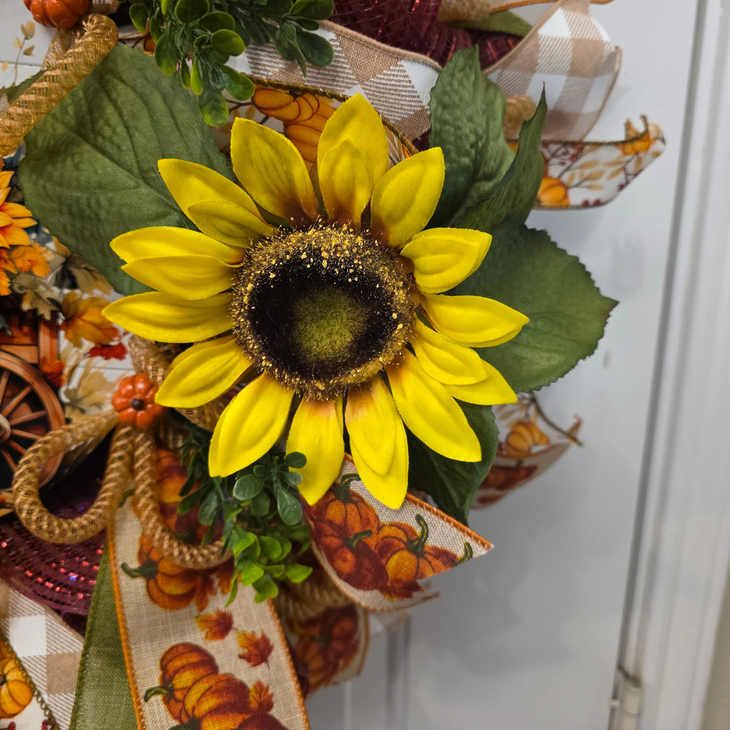 Close-up of orange sunflower with pumpkin sign centerpiece