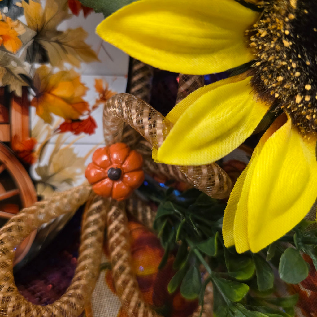 Wagon wheel sunflower centerpiece sign on fall wreath