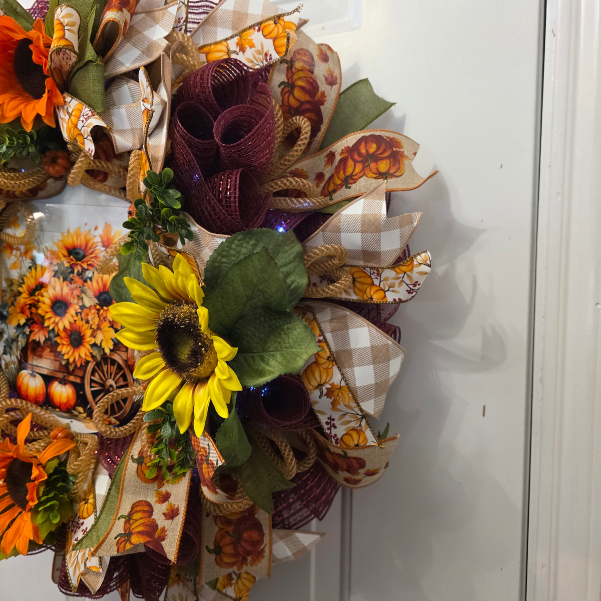 Buffalo plaid and pumpkin ribbon layers on fall wreath