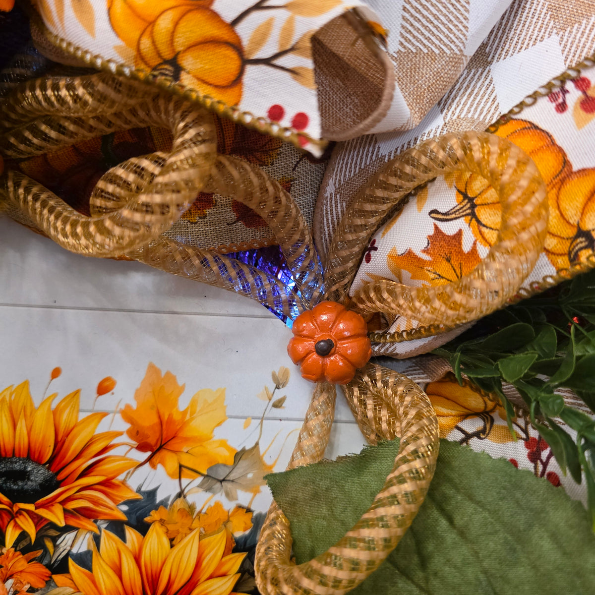 Fall sunflower wreath close-up showing orange sunflower and ribbons
