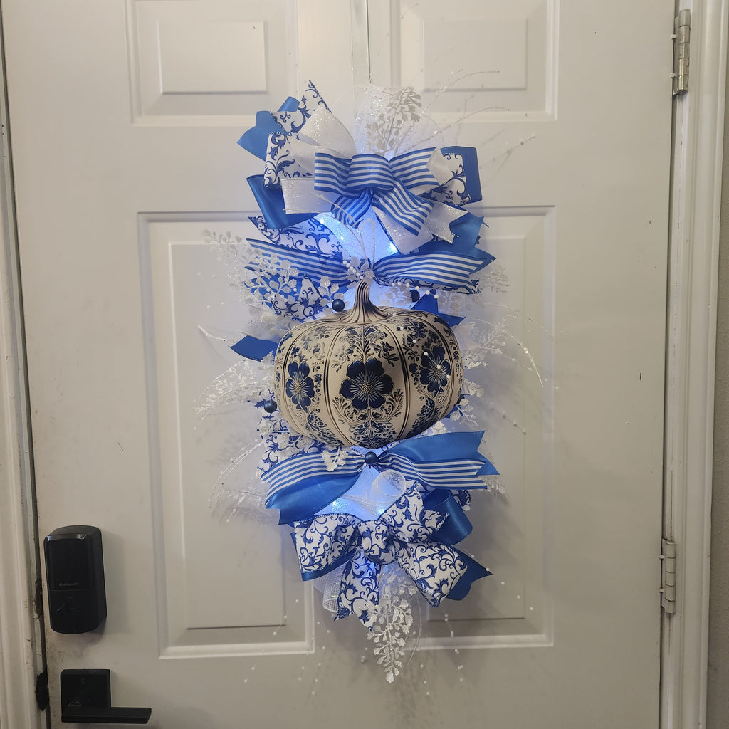 Close-up of layered blue and white ribbon bow on chinoiserie swag