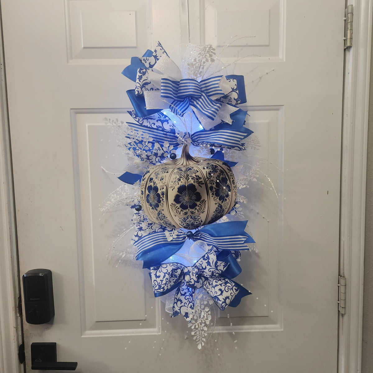 Close-up of layered blue and white ribbon bow on chinoiserie swag