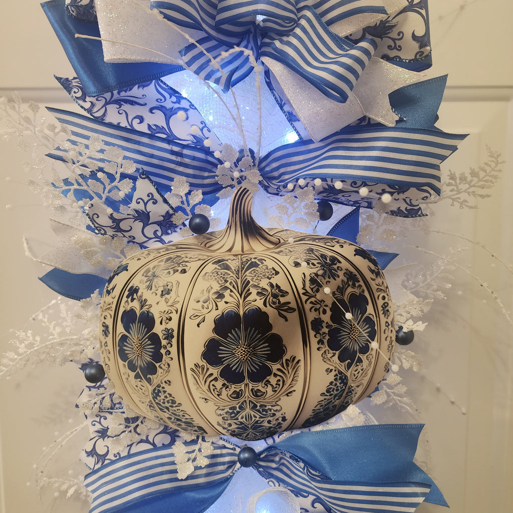Side view of blue and white chinoiserie door swag on white door