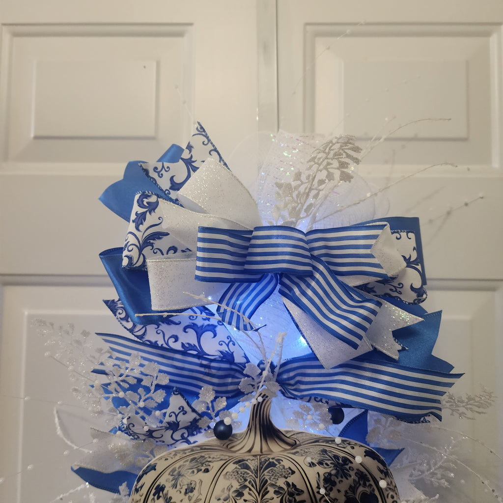 Royal blue satin and scrollwork ribbon bow close-up