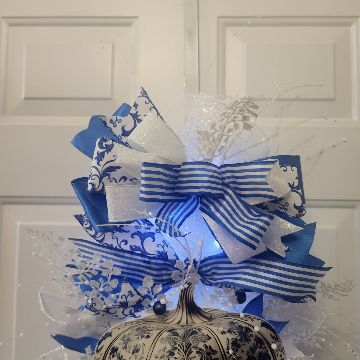 Royal blue satin and scrollwork ribbon bow close-up