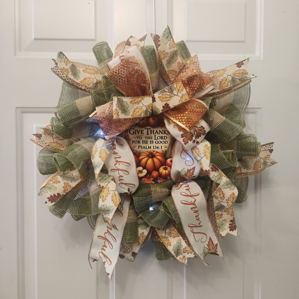 Close-up of copper glitter and oak leaf ribbon bow on Thanksgiving wreath