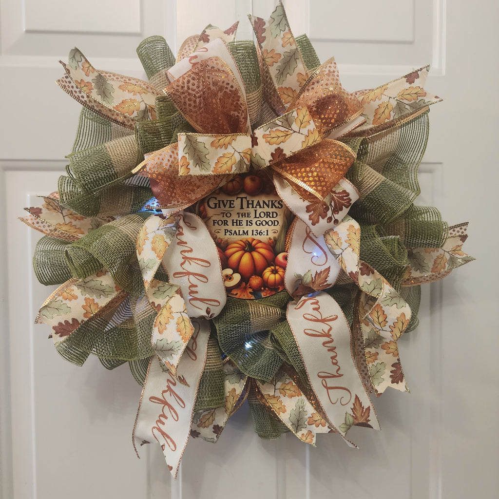 Full wreath view showing sage green mesh and layered ribbons