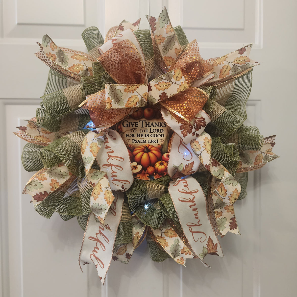 Side view of Give Thanks wreath hanging on white door