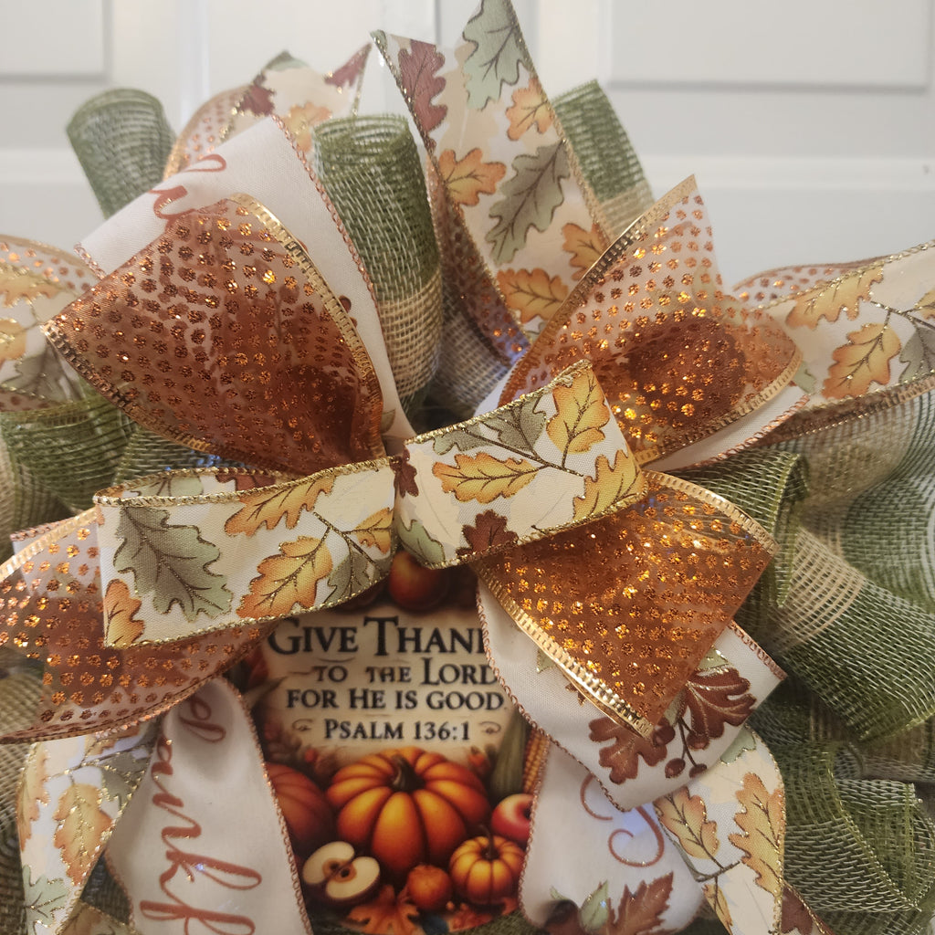Top view of ribbon loops and copper glitter accent on wreath