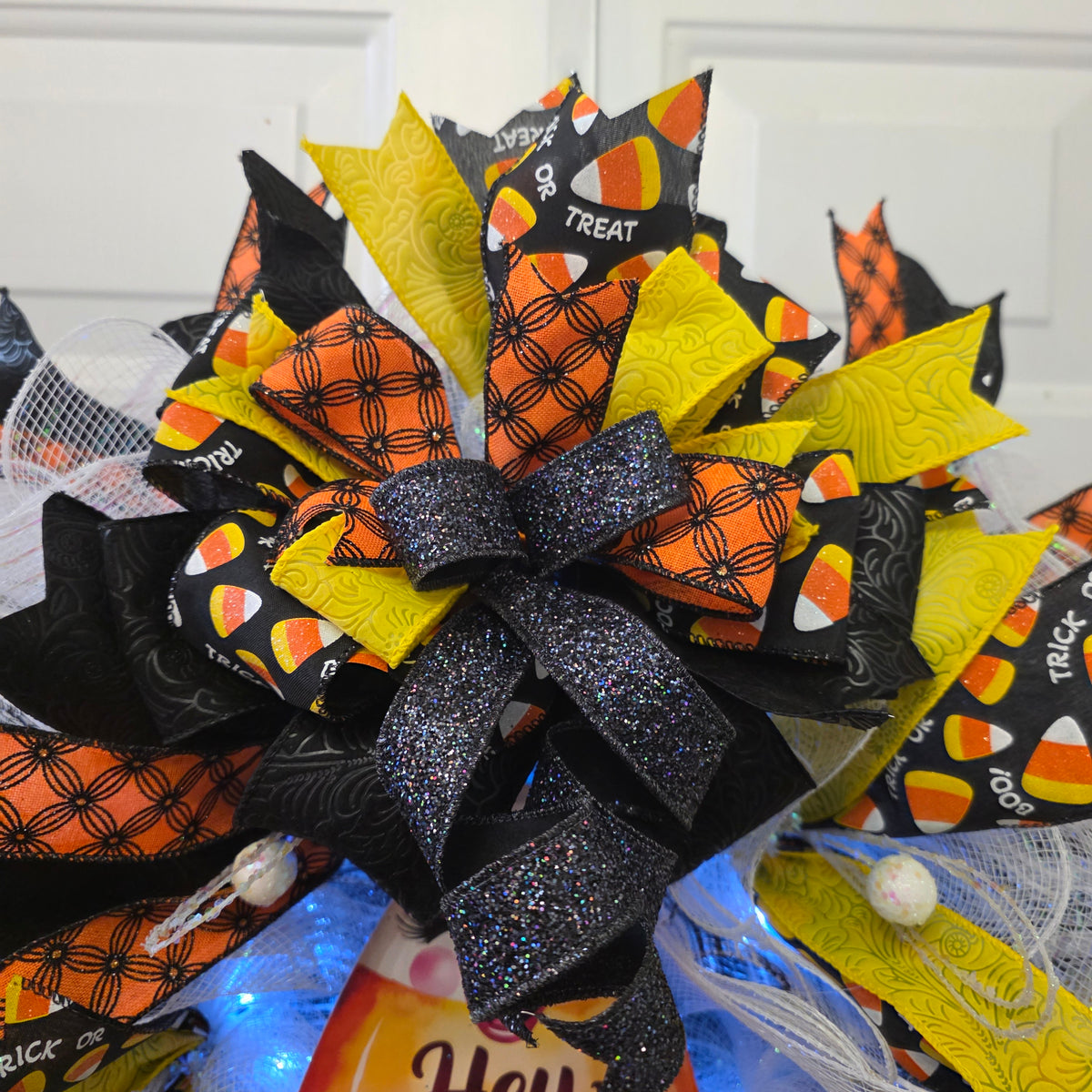 Hey Pumpkin wreath - angle view with blue fairy lights glowing