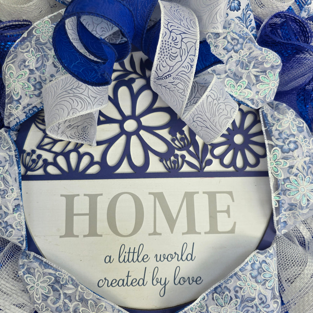Home A Little World Created By Love Blue White Wreath - full front view natural light