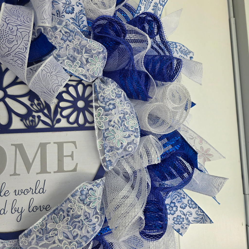 Home A Little World Created By Love Blue White Wreath - sign macro detail