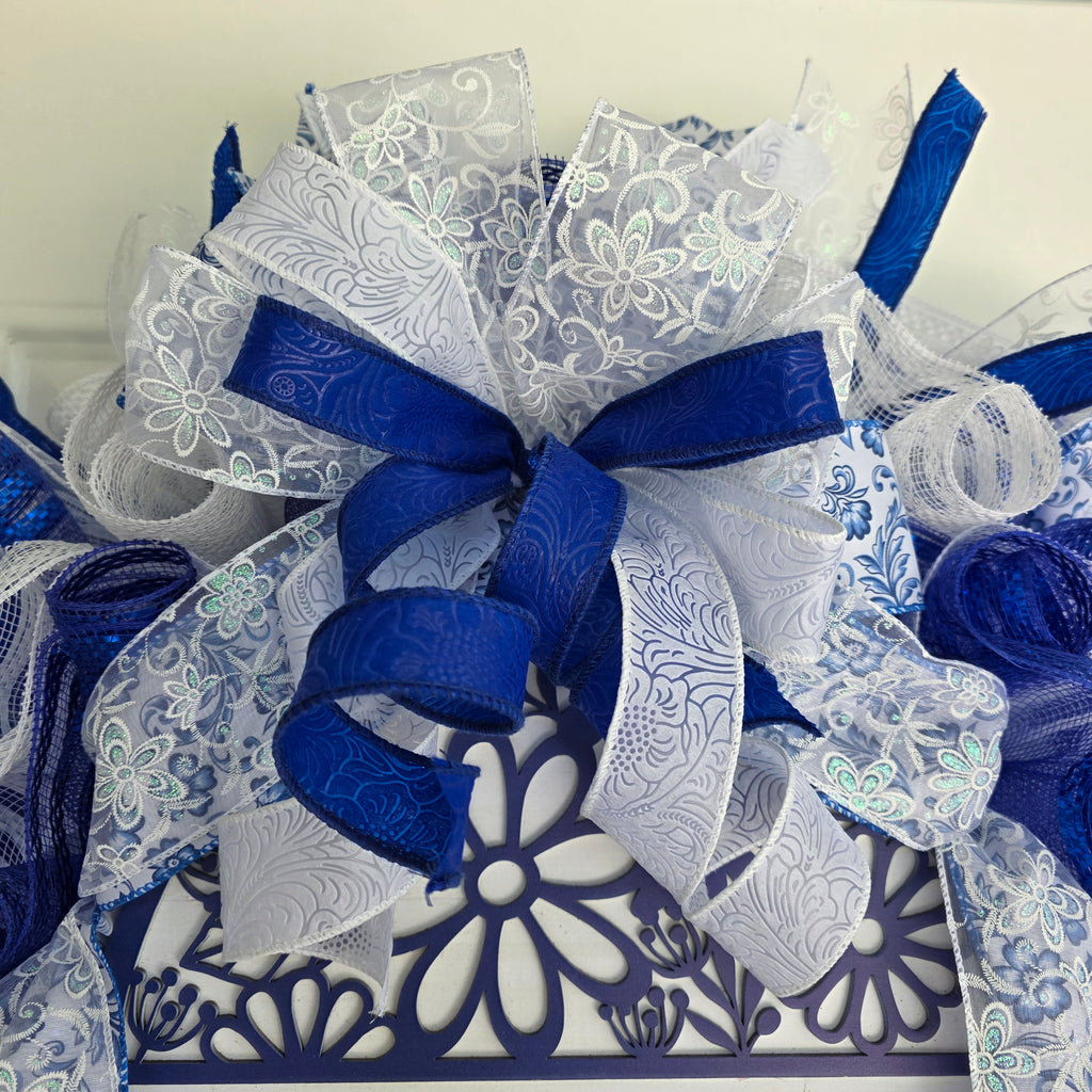 Home A Little World Created By Love Blue White Wreath - full front view on white door
