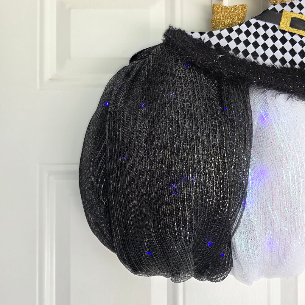 Harlequin Witch Hat LED Pumpkin Wreath - full side angle view on white door
