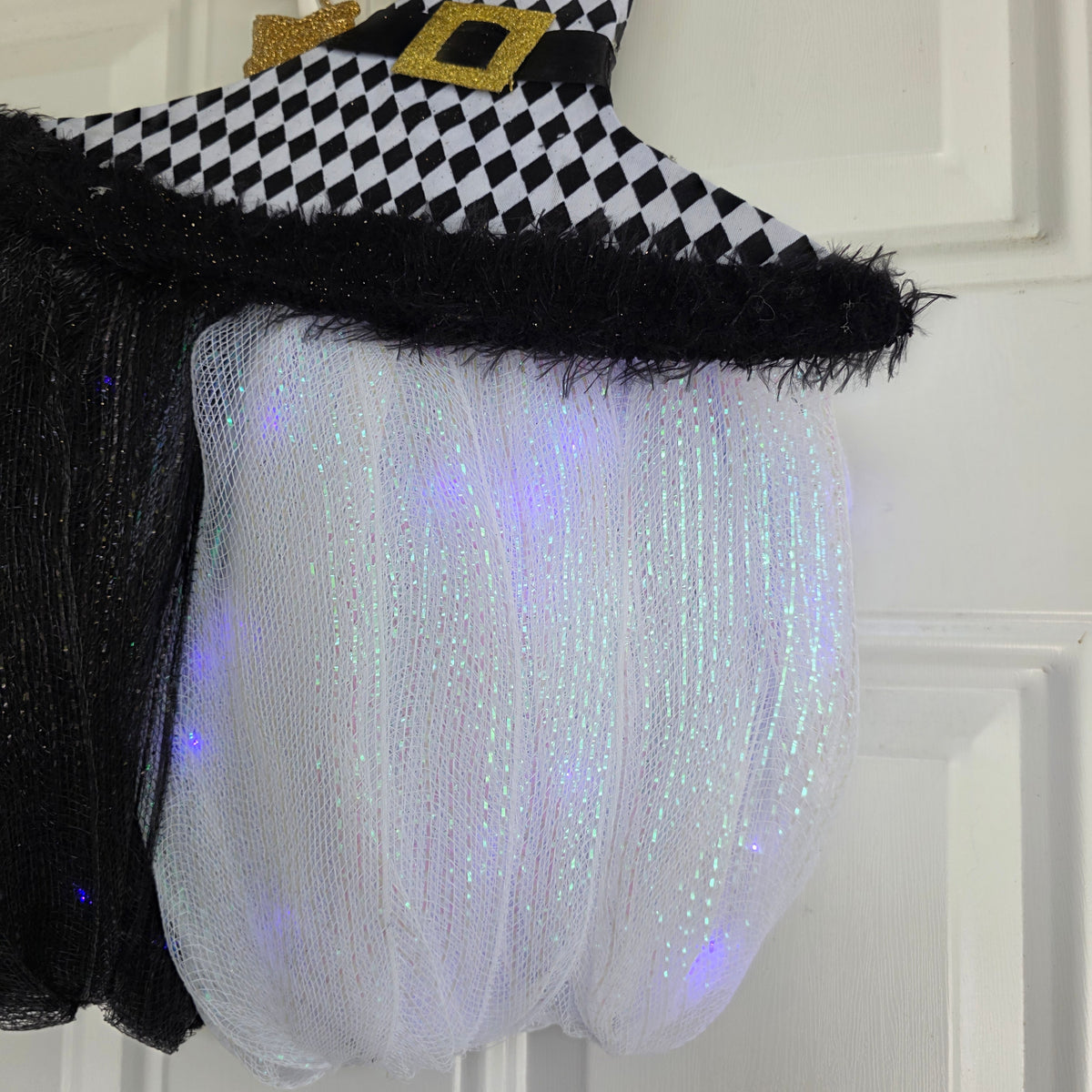 Harlequin Witch Hat LED Pumpkin Wreath - black glitter LED pumpkin close up