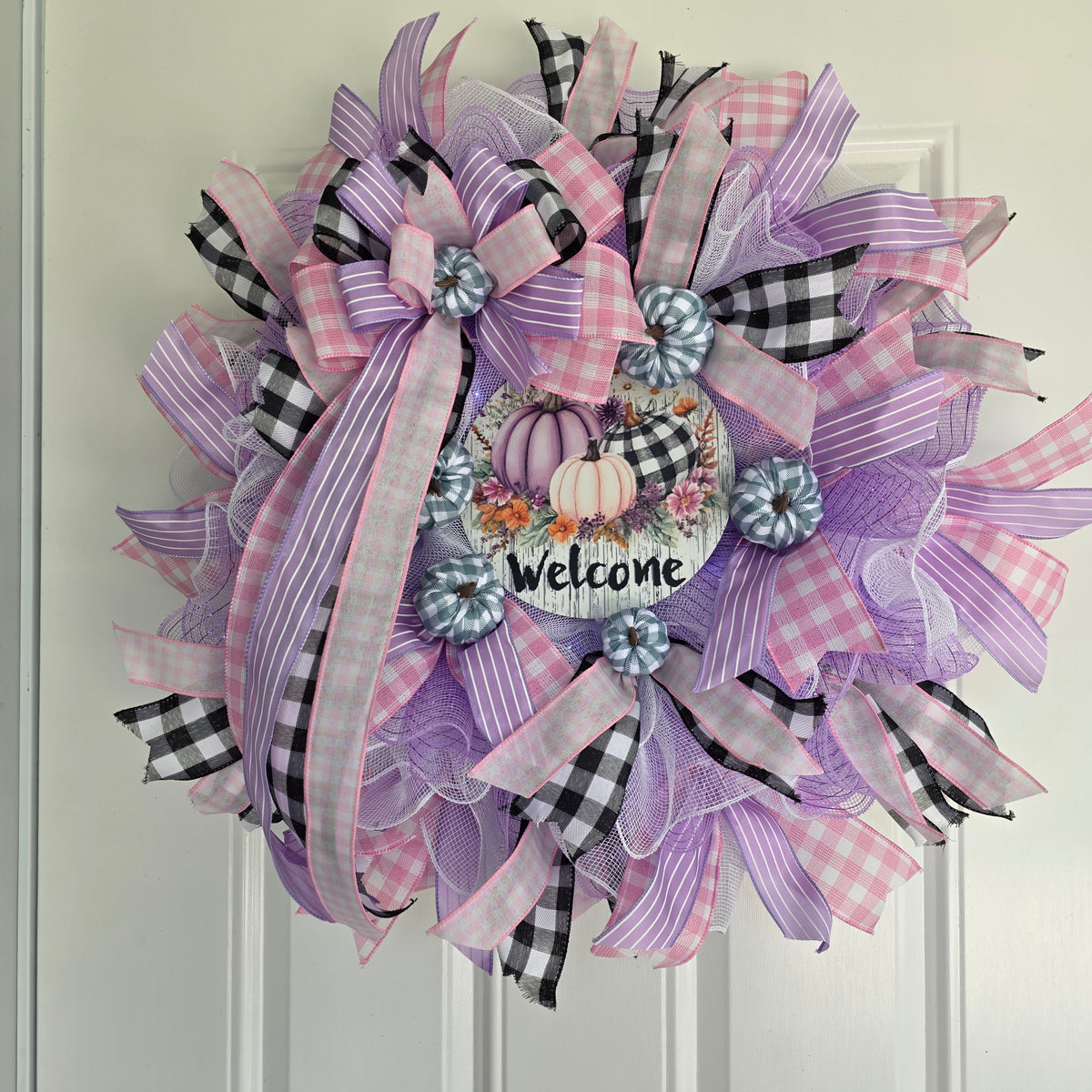 Purple Pumpkin Welcome Fall Wreath - side angle view on white door