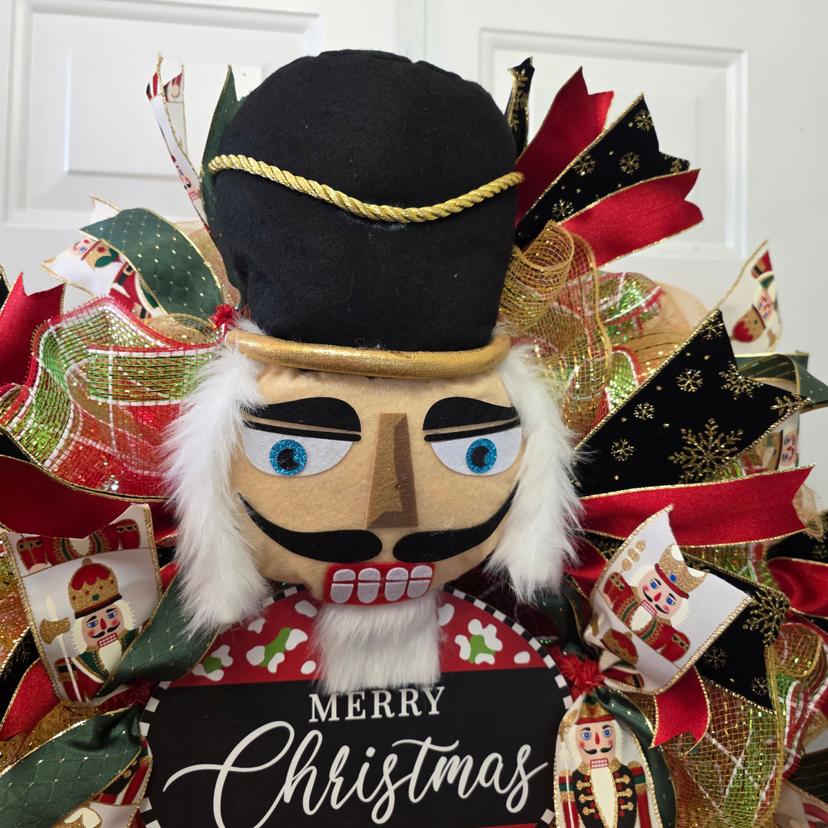 Nutcracker Christmas wreath with fairy lights and glitter ribbon