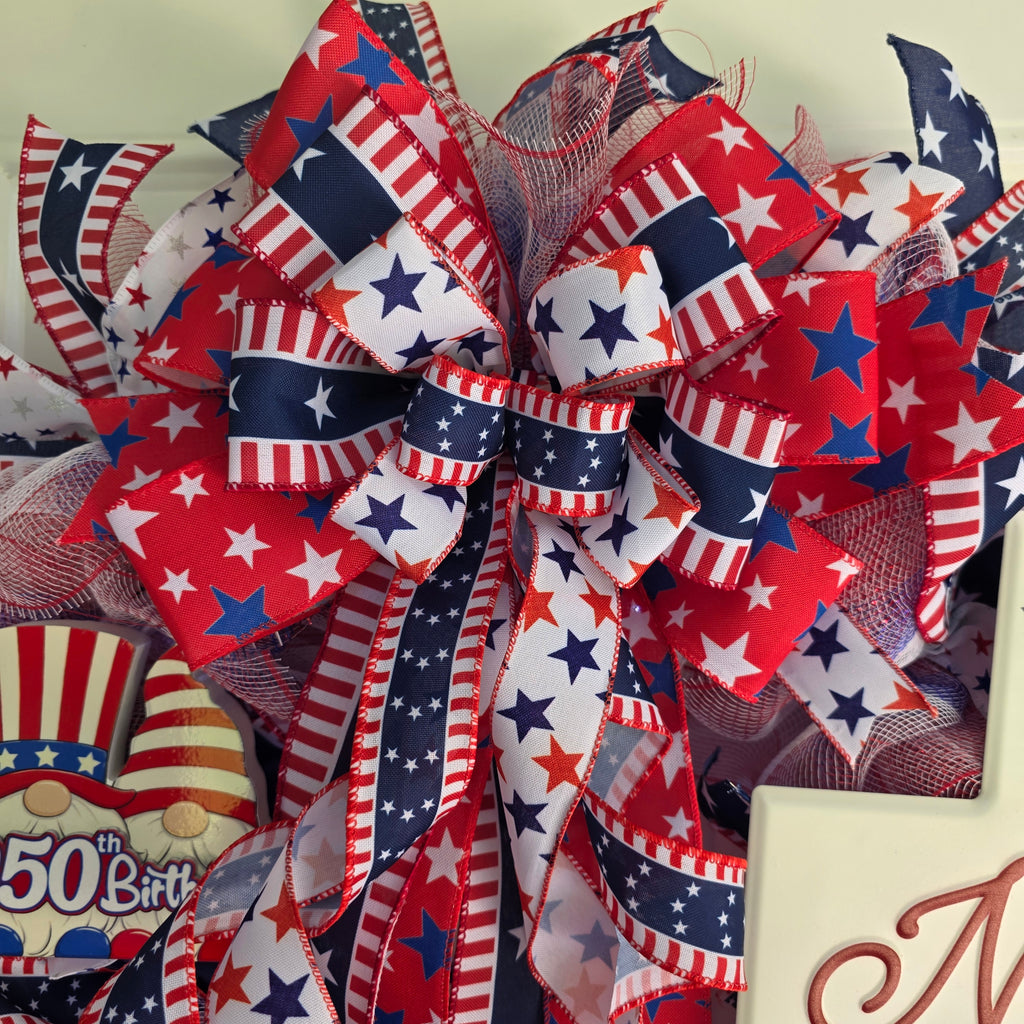 Top bow detail with layered red white blue star and stripe wired ribbons