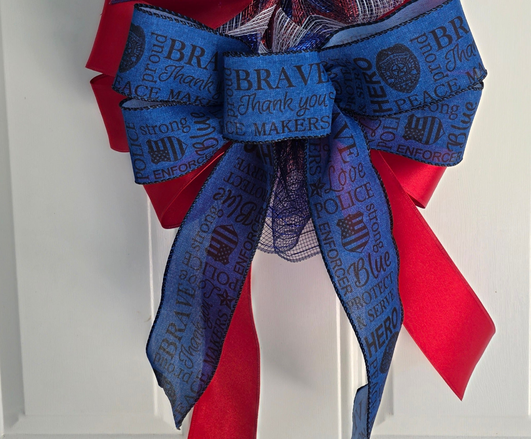 Top bow detail with glittery blue star picks and law enforcement word ribbon
