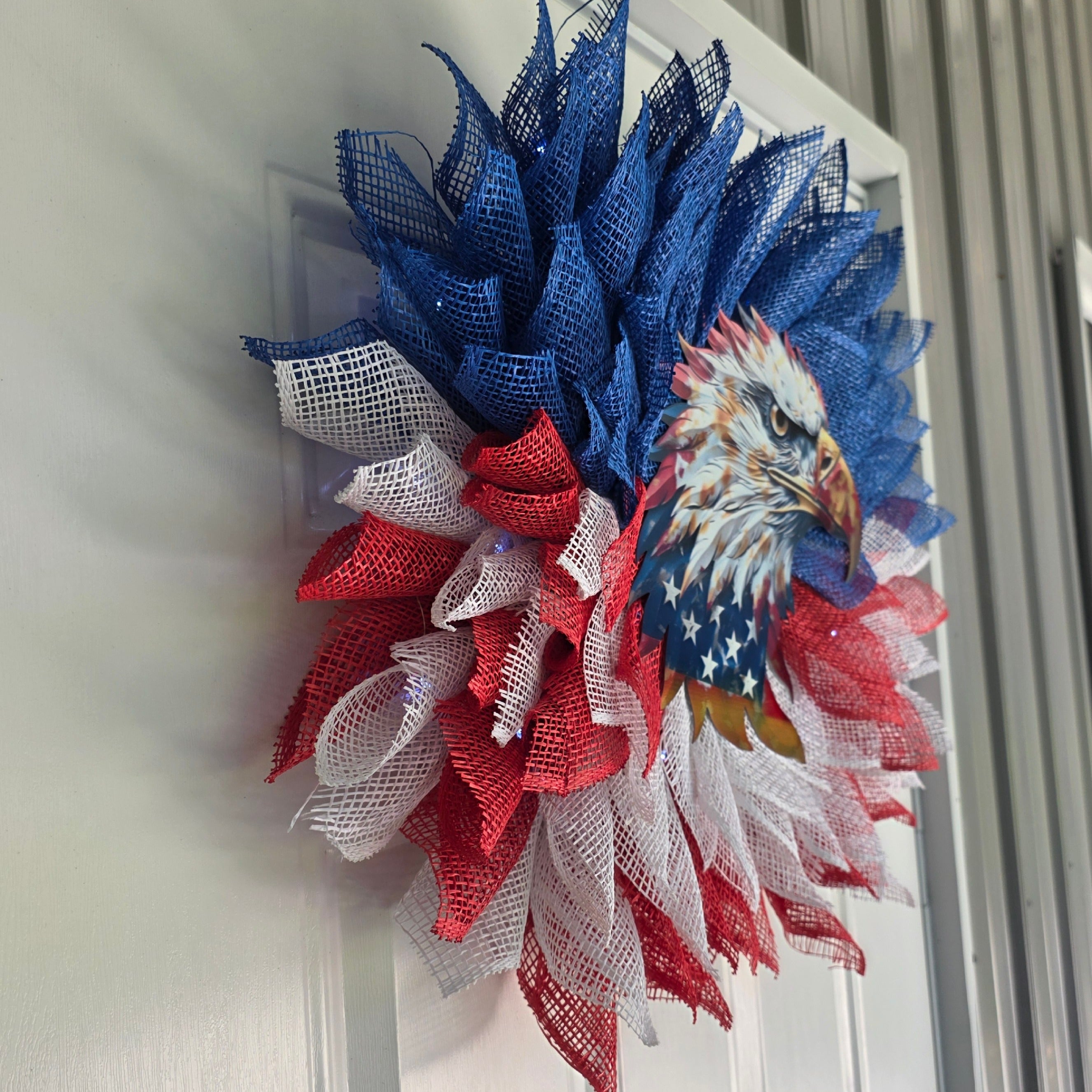 Left side view of patriotic bald eagle deco mesh wreath