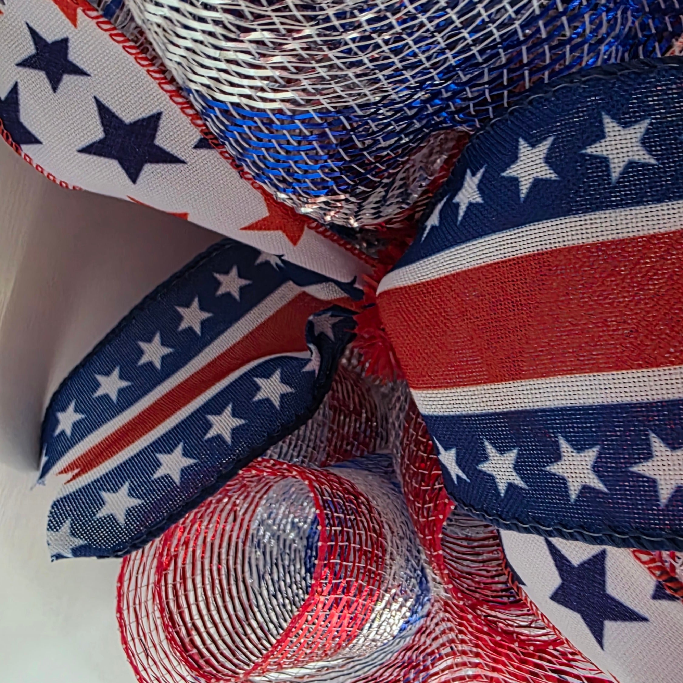 Close-up of American flag stripe ribbon and silver deco mesh detail