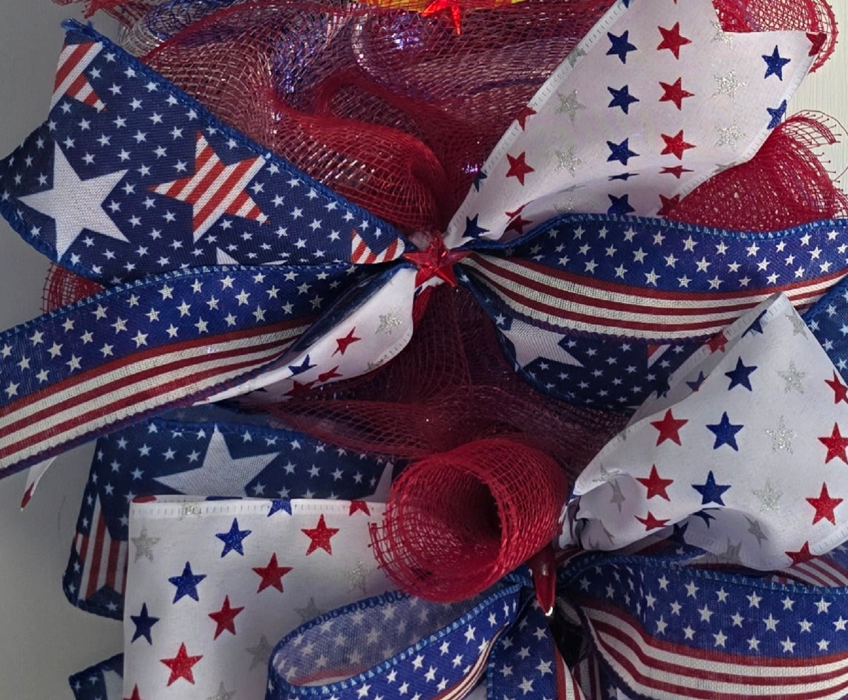 Close-up of layered navy star and red white blue stripe ribbon detail