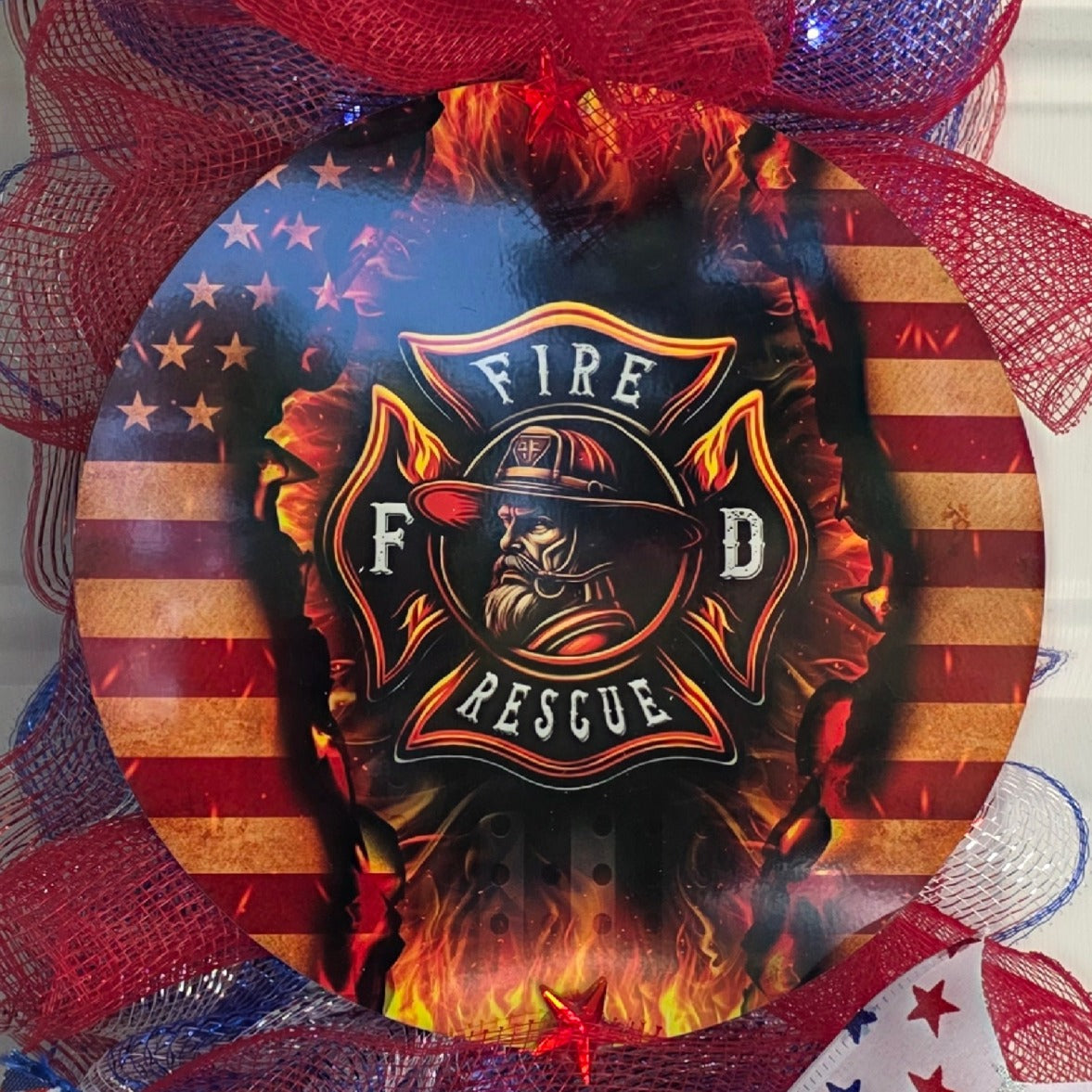 Close-up of Fire Rescue Maltese cross round center sign with flames and American flag