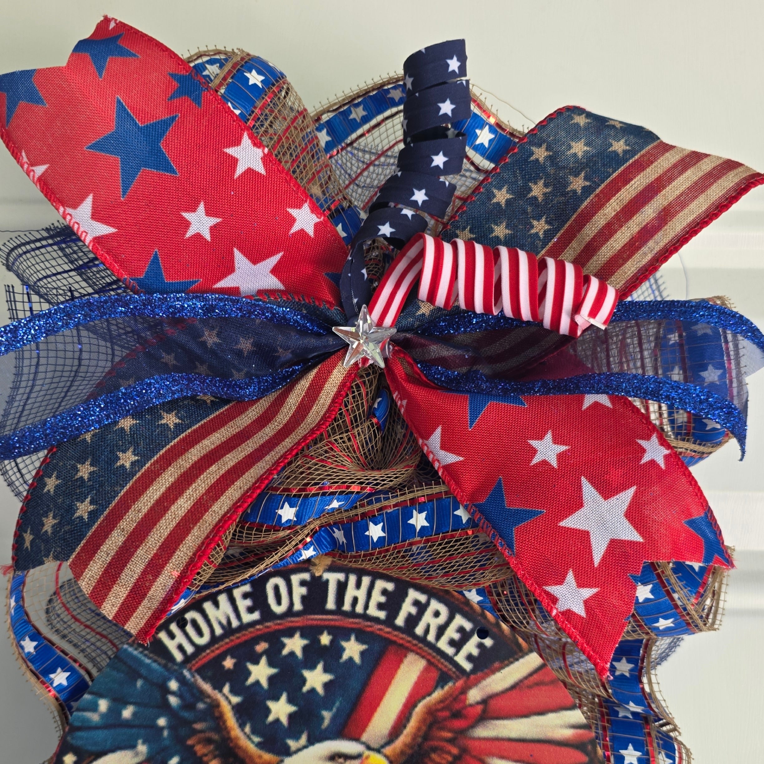 Top ribbon detail showing navy star and vintage flag stripe wired ribbons